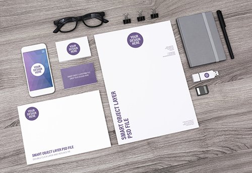 Smartphone and Stationery on Light Wooden Desk Mockup 1