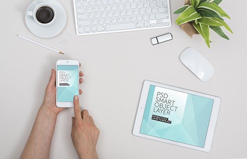 User with Smartphone and Tablet on White Desk Mockup
