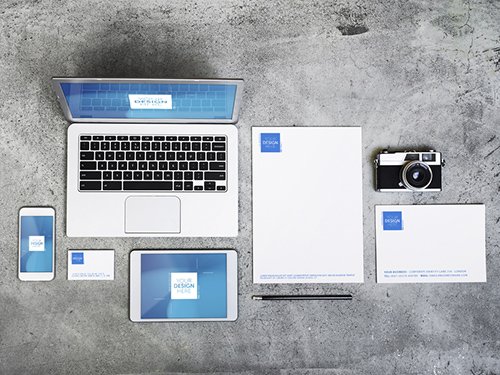 Devices, Laptop, and Stationery on Concrete Background Mockup 1
