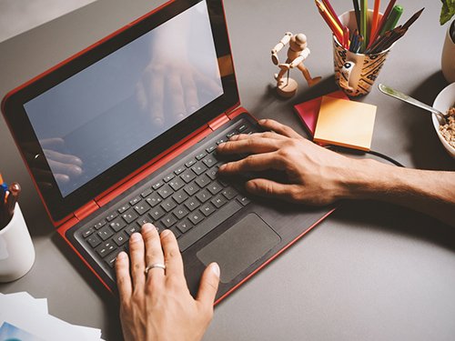 Laptop User Working on Gray Desk Mockup