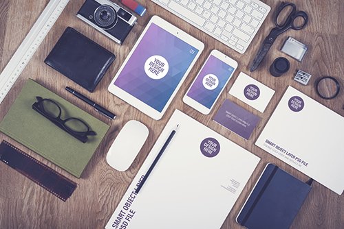 Smartphone, Tablet, and Stationery on a Wooden Desk Mockup 1