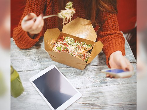 Woman Using Smartphone and Tablet While Eating Takeout Mockup